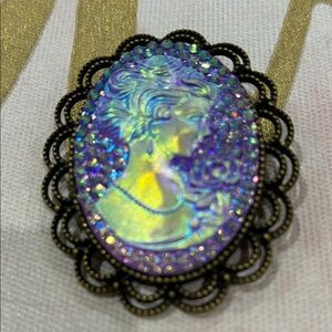 Elegant Cameo Brooch with Iridescent Purple and Gold Accents